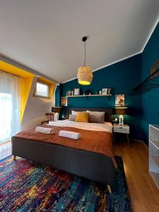 普里什蒂纳Light and Bright Central的一间卧室配有一张带蓝色墙壁的大床