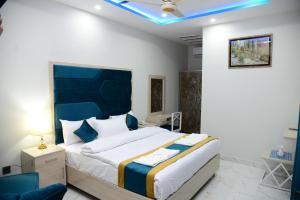 拉合尔Hotel Grand Lahore的一间卧室设有一张蓝色天花板的大床