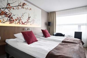 永比永比贝斯特韦斯特酒店的酒店客房 - 带两张带红色枕头的床