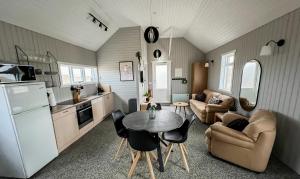 GardurGarður Apartments的厨房以及带桌椅的起居室。