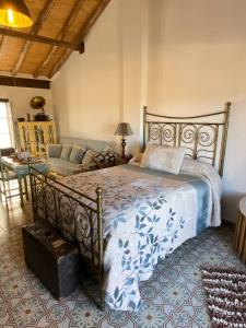 塞特尼尔El Escondite de Martina, Áticos Románticos的一间卧室配有一张大床和一张沙发