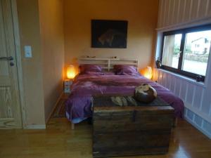 奥维法特Villa Angela, appartement 3 chambres的一间卧室配有一张带紫色床单的床和窗户。