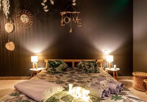 Le BreuilSweet Uni'vert Jacuzzi的一间卧室配有一张带蜡烛的床。