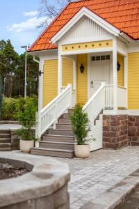 耶夫勒Trädgårdsmästarbostaden / The Gardeners Villa的黄色房子,有橙色屋顶