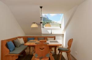 加尔米施-帕滕基兴Alpengold的一间带桌椅和窗户的用餐室