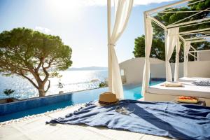 伊格拉恩TUI BLUE Makarska - Adults Only的配有帽子的床铺,享有游泳池的景色