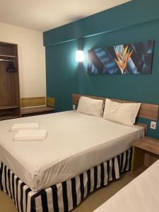 奥林匹亚Resort Solar das Águas的一间卧室设有一张蓝色墙壁的大床