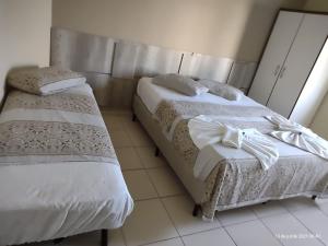 Hotel Pousada Miami客房内的一张或多张床位