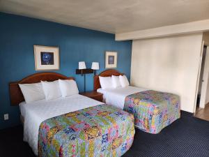 钱德勒钱德勒酒店的酒店客房,设有两张床和蓝色的墙壁