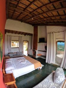 卡兰卡斯Pousada Mirante Serra Verde的一间卧室设有一张大床和两个窗户。