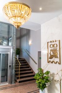 奥普尔皮亚斯特酒店的大楼的楼梯上有一个大吊灯