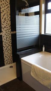 梅瓦吉西宝特梅伦湾住宿加早餐旅馆的带浴缸的浴室,配有窗户和浴缸