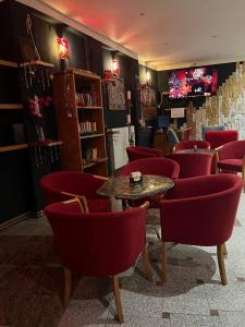 布拉格SIS画廊酒店的一间餐厅,房间内设有红色椅子和桌子