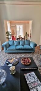 卡塔尼亚La Renaissance的客厅配有一张蓝色的沙发,配有一张桌子