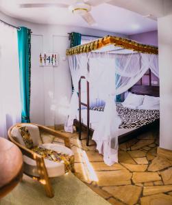 莫希Kilimanjaro Scenic Lodge的一间卧室配有一张带天蓬的床