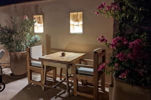 马拉喀什Riad Dar Eternity的花房里的木桌和椅子