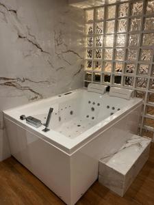 Triel-sur-SeineBulle Evasion的大理石墙客房内的白色浴缸