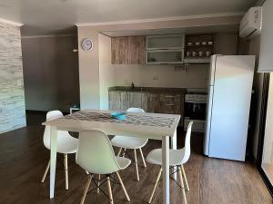 伊瓜苏港Perito Moreno - 3ro A的厨房配有桌椅和冰箱。