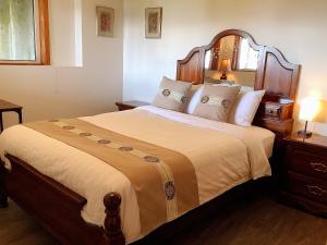 坎贝尔河Ocean's Edge Suite的一间卧室配有一张大床和木制床头板