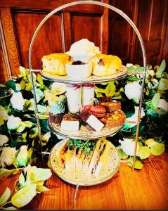 莫尔顿布里索普别墅酒店的一张三层的甜点和糕点展示在桌上
