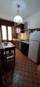 巴切诺La Beccaccia的厨房配有桌子和白色冰箱。