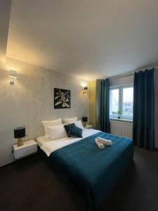 伊诺弗罗茨瓦夫Inna Strefa - Sleep & Restaurant的一间卧室配有一张带蓝色毯子的大床