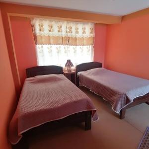 科帕卡巴纳阿雷格里港旅馆的带窗户的客房内的两张床