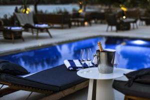 斯塔里格勒Waterfront Villa Antica, Cheerful 8 bedrooms with pool-Luxury is personal的游泳池旁的桌子,带酒杯