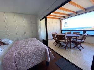 帕塔拉瓦卡100 m2 Penthouse on the beach.的卧室配有一张床和一张桌子及椅子