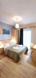 卡西奥皮The Central Villa - Kassiopi Corfu Villas的一间卧室配有一张床,上面有两条毛巾
