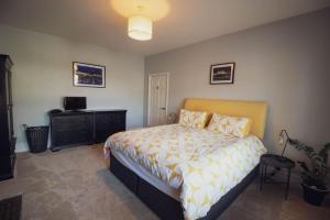 锡福德Beachy Head Apartment By Air Premier的一间卧室配有一张床、梳妆台和电视。