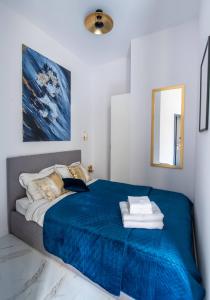 霍茹夫Apartamenty Yeti & Wilka w Centrum Chorzowa - Yeti的一间卧室配有一张带蓝色毯子的床
