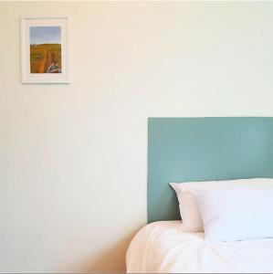 首尔Hostel Korea - Ikseon的卧室配有一张床,墙上挂着一幅画