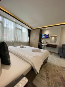 伊斯坦布尔Blue Mansion Hotel & Flats的一间卧室配有一张大床和电视