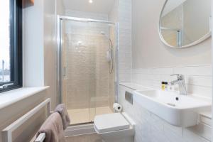格洛斯特Elliot Oliver - Stylish Loft Style Two Bedroom Apartment With Parking的一间带卫生间、水槽和镜子的浴室
