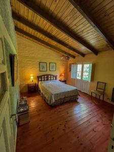 波特雷里约斯Casa de montaña en un lugar mágico的一间卧室配有一张床,铺有木地板
