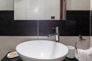 卡利亚里Locanda del buongustaio的浴室设有白色水槽和镜子