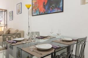 卡利亚里Locanda del buongustaio的一间设有玻璃桌和椅子的用餐室
