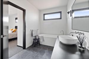 Rosa GlenRuse Estate Retreat Margaret River的白色的浴室设有浴缸和水槽。