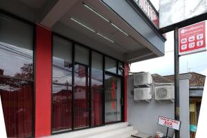 马格朗RedDoorz near Alun Alun Magelang 2的街道上装有黑色和红色窗户的商店前