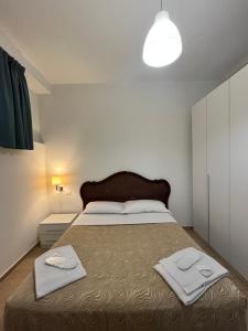 米兰Rucellai Guest House的一间卧室配有一张大床和两条毛巾