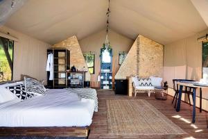 凯阿玛Cicada Luxury Camping的卧室配有一张床和一张桌子