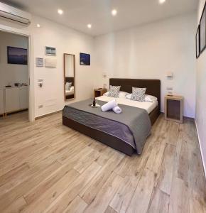 索伦托Effe Home Sorrento的一间卧室设有一张大床,铺有木地板