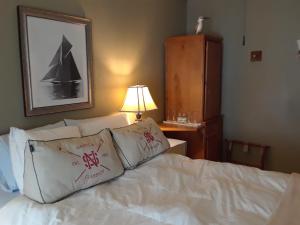 East MiddleburyWaybury Inn的一间卧室配有带白色床单和枕头的床。