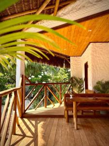 皮帕Casa Palmeira的甲板上设有木门廊和长凳