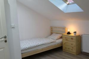 BernauFerienwohnung Stefanko的一间卧室配有一张床、梳妆台和天窗