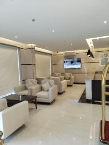 Al MikhlafAl Shark Park Serviced Apartment的带沙发和平面电视的客厅