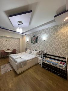 第比利斯萨纳皮罗第比利斯酒店的一间卧室配有一张大床和一张桌子