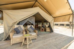 SinoniAfrica Safari South Serengeti Ndutu Ngorongoro的帐篷前配有椅子和桌子