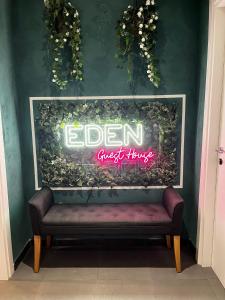 罗马Eden guest house的墙上的标牌,在房间里设有长凳